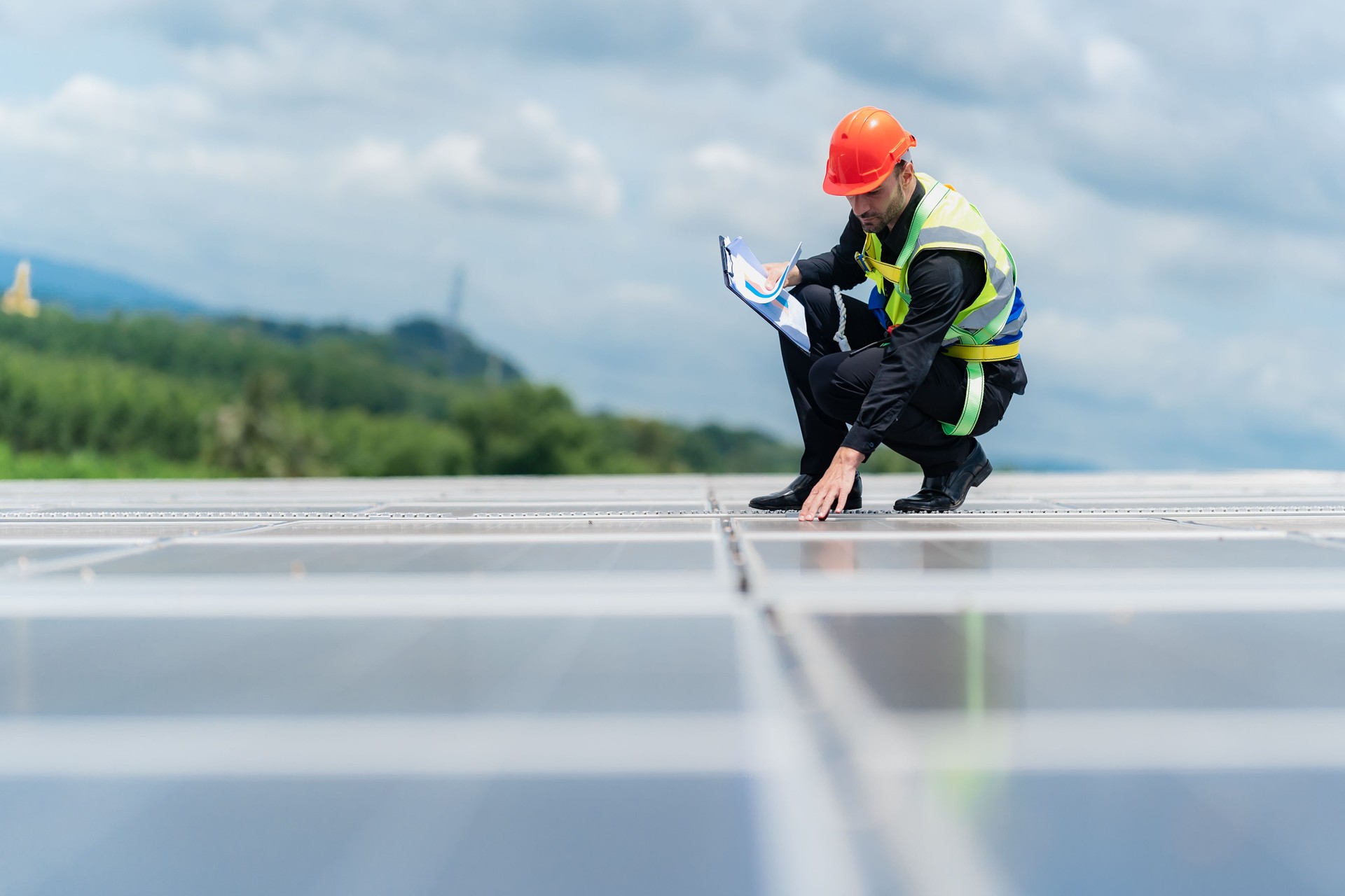 professional safety engineering man has service checking roof top of solar power construction under sunlight, engineering man working under the sunlight renewable the solar for eco energy environment.