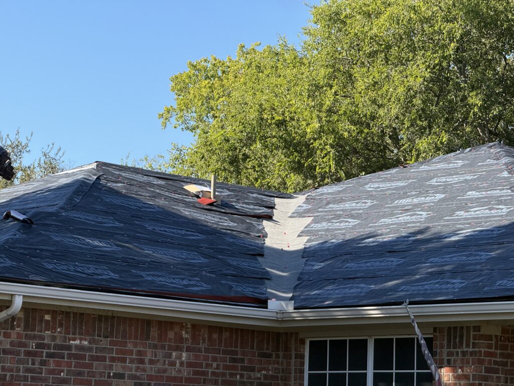 Roof valley and slopes covered with underlayment during replacement