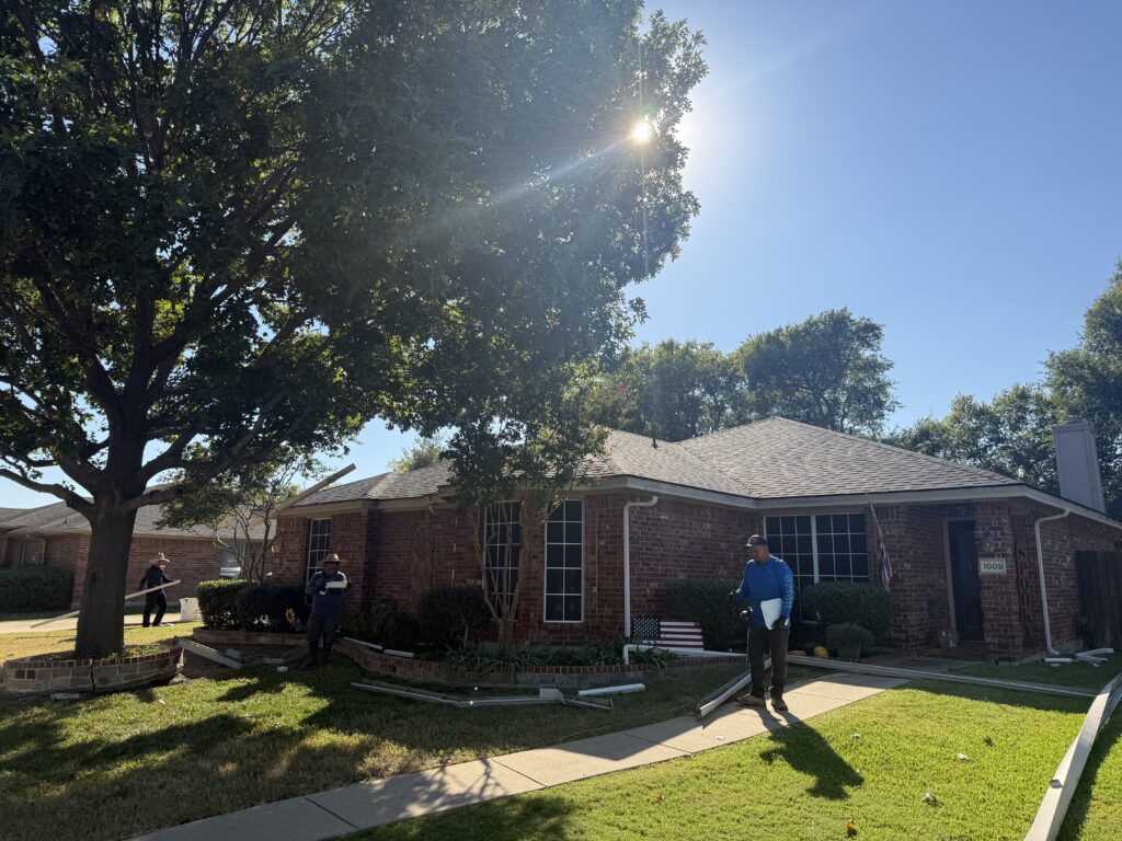 Completed asphalt shingle roof on a one-story brick home